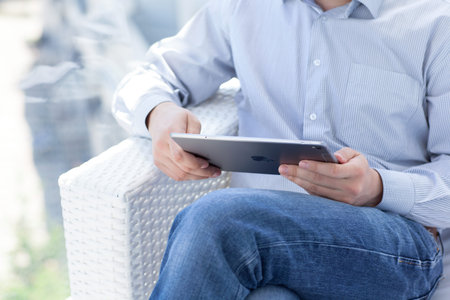 Alushta, Russia - May 14, 2016: Man holding in the hand a new iPad Pro Space Gray. iPad Pro was created and developed by the Apple inc.のeditorial素材
