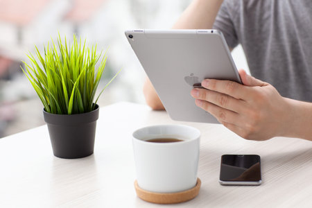 Alushta, Russia - May 30, 2016: Man holding in the hand a new iPad Pro Space Gray. iPad Pro was created and developed by the Apple inc.のeditorial素材