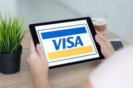 Alushta, Russia - September 15, 2016: Woman holding a iPad Pro with payment system service Visa on the screen. iPad Pro 9.7 Space Gray was created and developed by the Apple inc.のeditorial素材