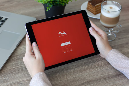 Alushta, Russia - October 9, 2016: Woman holding a iPad Pro Space Gray with image hosting and social networking service Path on the screen. iPad Pro 9.7 was created and developed by the Apple inc.のeditorial素材