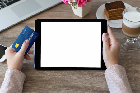 woman hands holding credit card and tablet computer PC with isolated screenの写真素材