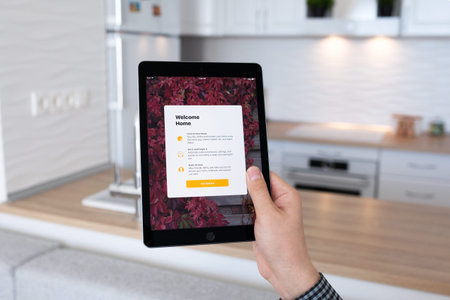 Alushta, Russia - October 29, 2016: Man hand holding iPad Pro Space Gray with app Home in the...