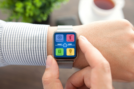 Man hands with smart watch app smart home on screen の写真素材