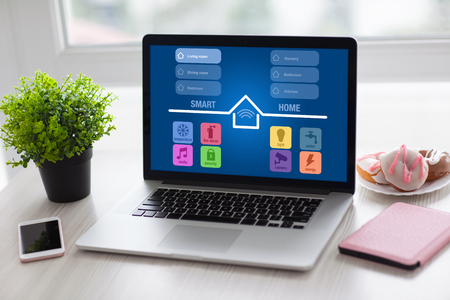 laptop notebook with app smart home and phone on desk in room の写真素材