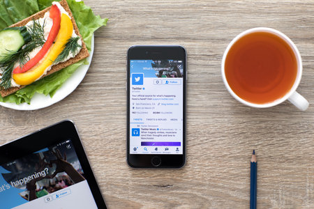 Alushta, Russia - May 24, 2017: iPhone and iPad on the table with social networking service Twitter on the screen. iPad Pro was created and developed by the Apple inc.のeditorial素材