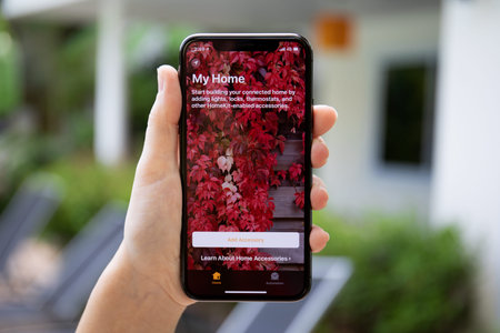 Koh Samui, Thailand - March 30, 2018: Woman hand holding iPhone X with app Home in the screen....