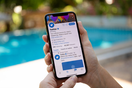 Koh Samui, Thailand - March 21, 2018: Woman hand holding iPhone X with social networking service Twitter on the screen. iPhone 10 was created and developed by the Apple inc.のeditorial素材