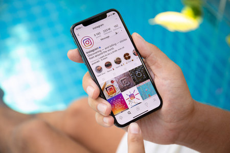 Koh Samui, Thailand - March 22, 2018: Man hand holding iPhone X with social networking service Instagram on the screen. iPhone 10 was created and developed by the Apple inc.のeditorial素材