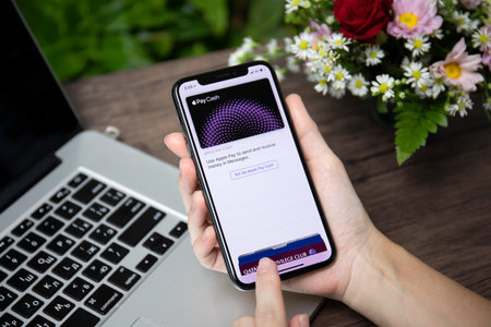 Koh Samui, Thailand - March 23, 2018: Woman hand holding iPhone X with Apple Pay Cash on the screen. iPhone 10 was created and developed by the Apple inc.のeditorial素材