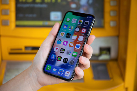 Koh Samui, Thailand - March 25, 2018: Woman hand holding iPhone X with home screen IOS. iPhone 10...