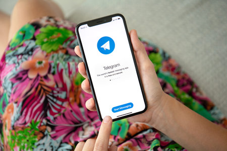 Alushta, Russia - September 27, 2018: Woman hand holding iPhone X with social networking service...