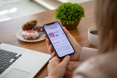 Alushta, Russia - September 28, 2018: Woman hand holding iPhone X with social networking service...