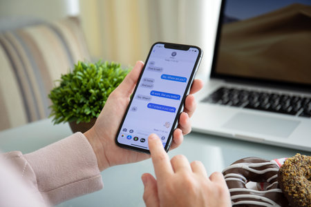Alushta, Russia - September 28, 2018: Woman hand holding iPhone X with social networking service...
