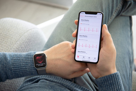 Anapa, Russia - February 17, 2019: Man hand with Apple Watch Series 4 and iPhone X with the ECG app...