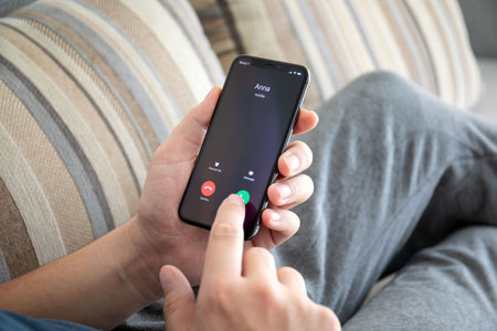 Alushta, Russia - October 9, 2018: Man hand holding iPhone X with call number on the screen. iPhone 10 was created and developed by the Apple inc.のeditorial素材