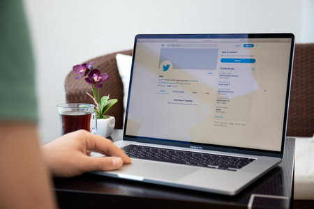 Alanya, Turkey - April 10, 2020: Man hand on Macbook Pro 16 in the table with social networking service Twitter on the screen. Macbook was created and developed by the Apple inc.のeditorial素材