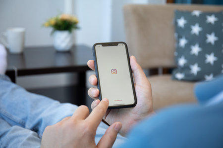 Alanya, Turkey - May 9, 2020: Man hand holding iPhone 11 with social networking service Instagram on...