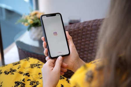 Alanya, Turkey - July 10, 2020: Woman hand holding iPhone 11 with phone call widget on the home screen. iPhone 11 was created and developed by the Apple inc.のeditorial素材