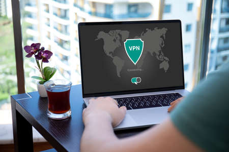 man uses app vpn creation Internet protocols for protection private network on screen computer laptopの写真素材