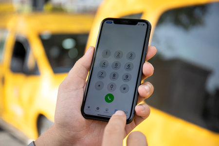 Alanya, Turkey - October 8, 2020: Man hand holding Apple iPhone 11 with call Taxi on the screen. Apple iPhone 11was created and developed by the Apple inc.のeditorial素材