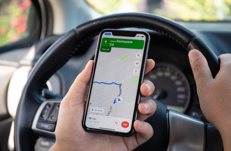 Alanya, Turkey - October 5, 2020: Man hand holding Apple iPhone 11 with Google Navigation Maps on...