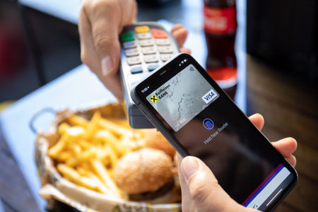 Alanya, Turkey - October 13 2020: Man hand holding iPhone 11 with Apple Pay on the screen and pay...