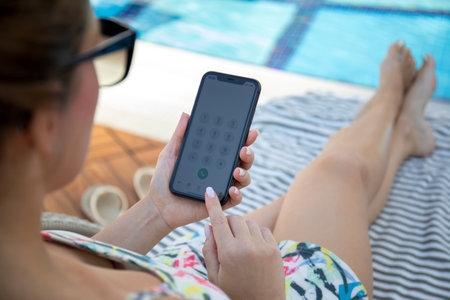 Alanya, Turkey - November 2, 2020: Woman hand holding iPhone 11 with call number on the screen IOS 14. iPhone was created and developed by the Apple inc.のeditorial素材