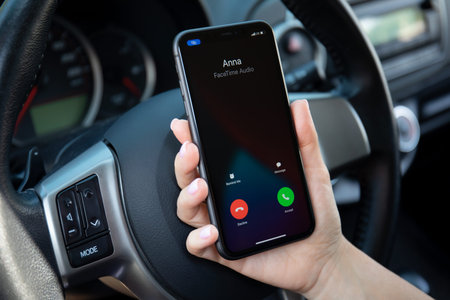 Alanya, Turkey - September 23, 2020: Woman hand holding iPhone 11 with Widgets call phone on the...