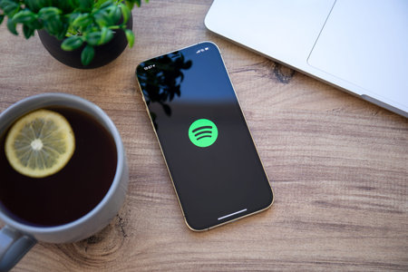 Alanya, Turkey - December 6, 2020: iPhone 11 Pro Max Gold with cloud audio streaming and music service Spotify on the screen.のeditorial素材