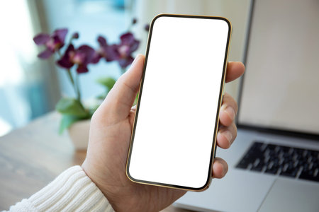 Man hands holding golden phone with isolated screen over white table in office
