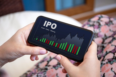 female hands hold phone with IPO stocks purchase app on screen