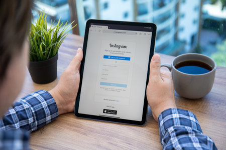 Alanya, Turkey - May 14, 2021: Man hand holding iPad Air with social networking service Instagram on the screen.のeditorial素材