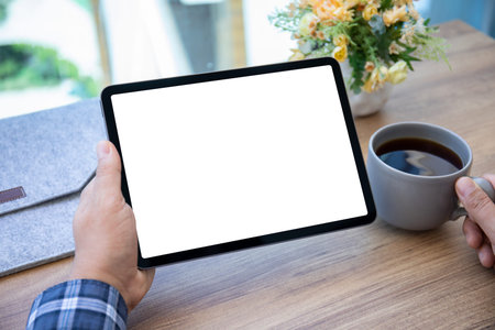 male hands holding computer tablet with isolated screen over table in cafe