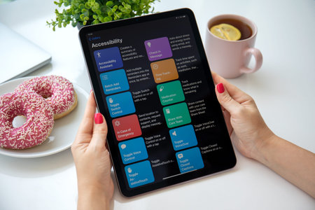 Alanya, Turkey - August 6, 2021: Woman hand holding iPad Air Space Gray with home screen Shortcuts...
