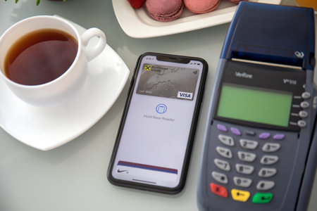 Anapa, Russia - October 1, 2019: Apple iPhone 11 with app Raiffeisenbank on the screen and pay pass...