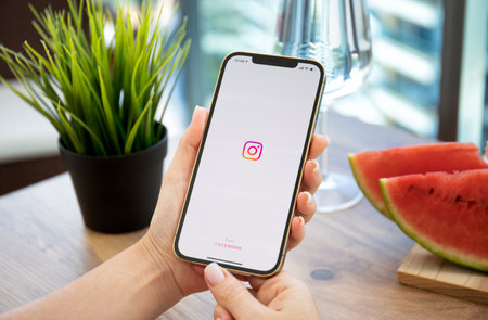 Alanya, Turkey - October 11, 2021: Women hand holding iPhone 12 Pro Max Gold with social networking service Instagram on the screen.のeditorial素材