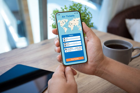 man hand holds phone with application searching air tickets on the screen over table in cafe