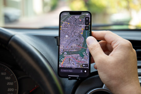 Alanya, Turkey - September 22, 2022: Man hand holding Apple iPhone 14 with Google Navigation Maps on the screen. Apple iPhone 14 was created and developed by the Apple inc.のeditorial素材