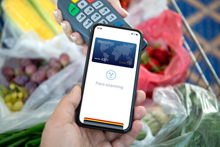 Man and woman payment purchase for phone with face scanning ID and payment purchase on pay pass online terminal in supermarketの写真素材