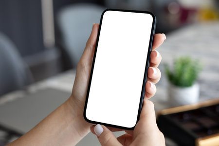 woman hand hold phone with isolated screen background of the officeの写真素材