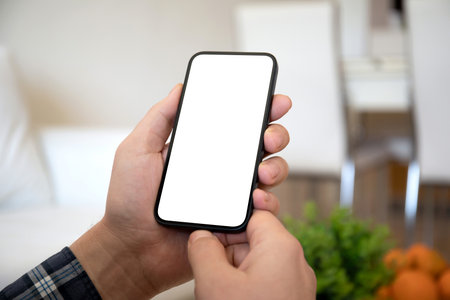 male hands hold phone with isolated screen background of summer cafeの写真素材
