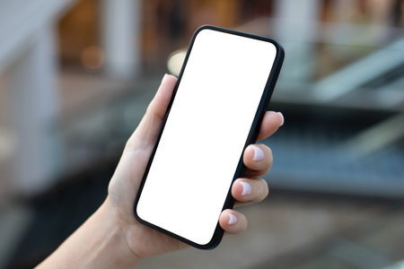 Female hand hold phone with isolated screen background of office buildingsの写真素材