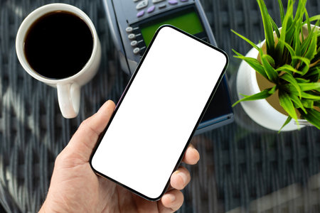 Man payment purchase for phone with isolated screen and pay pass online terminal in cafeの写真素材