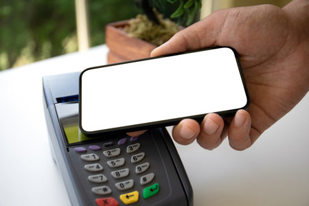 Man payment purchase for phone with isolated screen and pay pass online terminal in cafeの写真素材