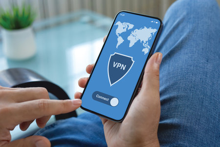 male hands hold phone with app vpn on screen background of jeans in the roomの写真素材