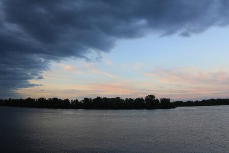 River at sunset in cloudy weatherの写真素材