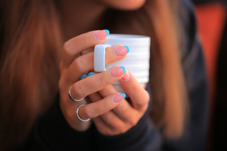 Coffee cup in woman hand close-upの写真素材