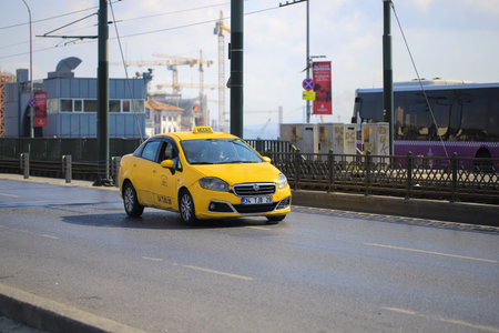 Yellow taxi car rides on the road