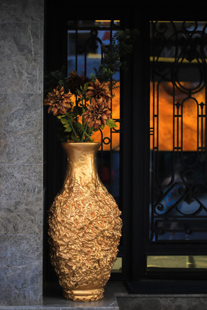 Large golden vase on the street near the hotel doorの写真素材