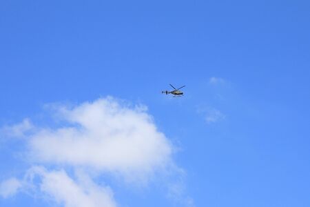 Helicopter fly in the blue skyの写真素材